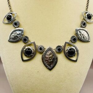 Hammered silver eye shapes with black beads necklace. Tribal style. Bib necklace